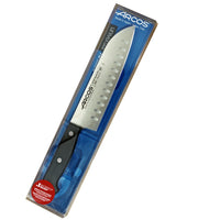 Arcos Santoku Ovaalihiottu, 17 cm - Laatuveitsi Ammattilaisille, pakattu läpinäkyvään pakkaukseen, esittelee Nitrum-teräksen ja ovaalihionnan.