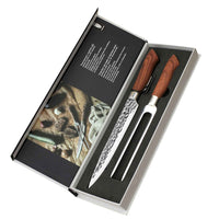 Avoin Dorre paistiveitsien ja haarukan lahjapakkaus, sisältäen tyylikkäästi esille asetetut keittiövälineet ja tuotetiedot.