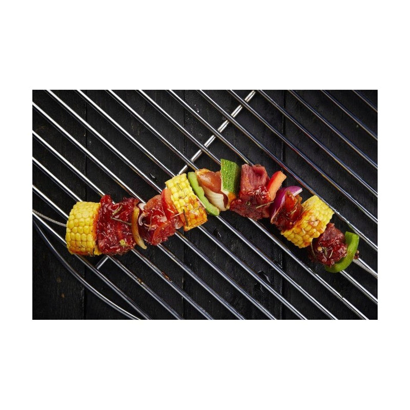 Grillivarras setti käytössä grillissä, vartaisiin pujotettu lihaa ja vihanneksia, täydellinen grillauskeittiöväline.